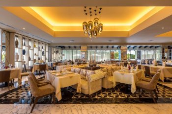 Interior of Trattoria Italian restaurant at Moon Palace Cancun with elegant seating and warm lighting