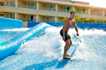 FlowRider surf simulator at Moon Palace Cancun with guests bodyboarding on artificial waves