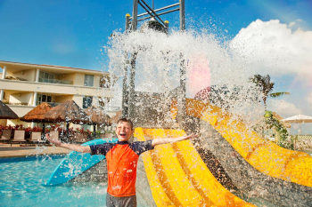 Child playing in kids pool with water slides at Moon Palace Cancun family-friendly resort